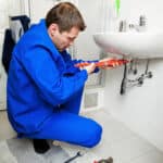 plumber repairing sink pipe