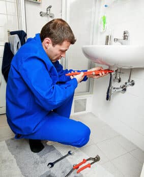 plumber repairing sink pipe