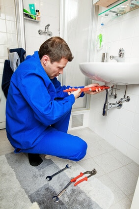 plumber repairing sink pipe