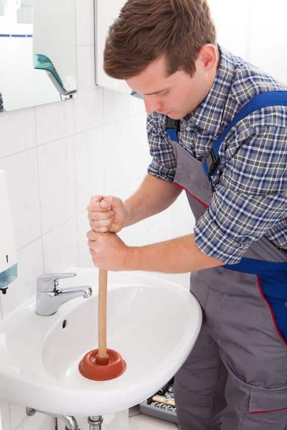 plumber unclogging sink