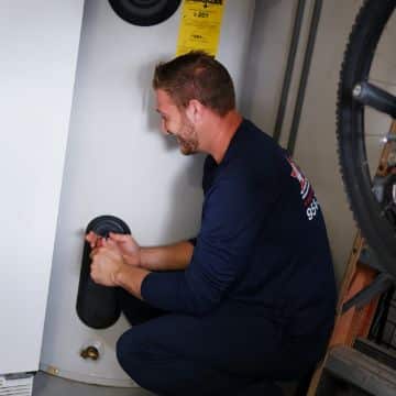 4 Star Plumbing Services staff checking water heater tank