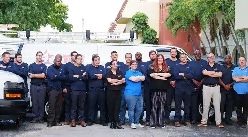 4 star plumbing services employees posing in front of office