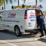 plumber loading equipment into work van