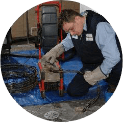 plumber performing drain cleaning service