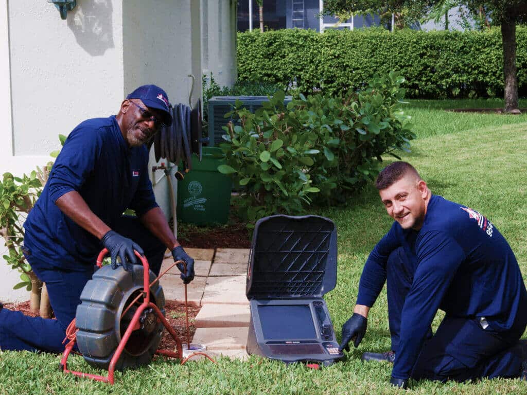 plumbers performing drain inspection