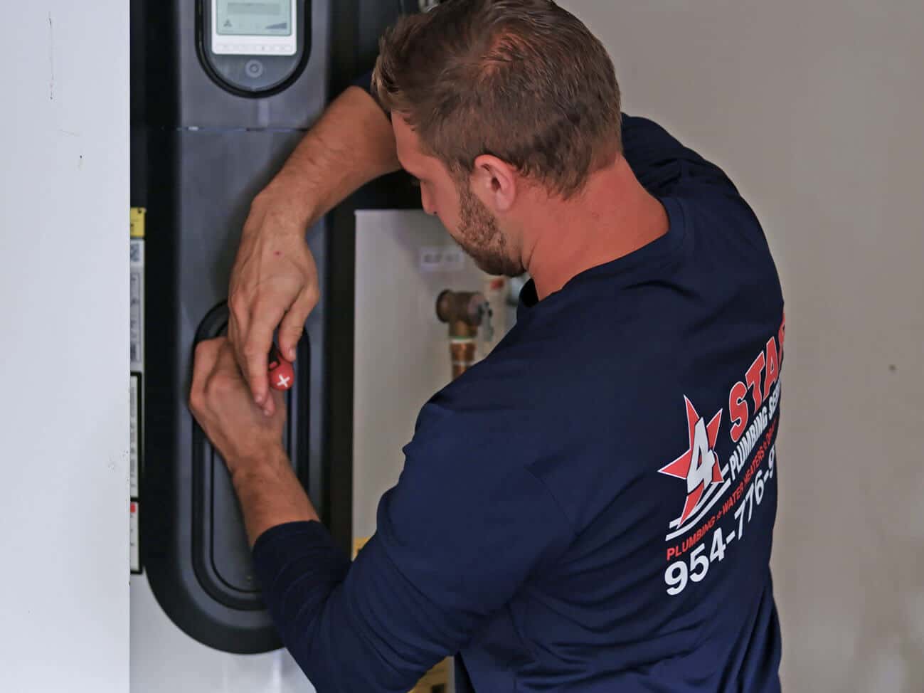 plumber installing commercial pumps and controls