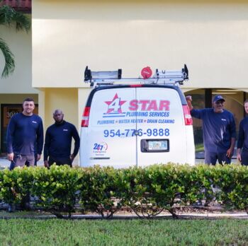 plumbers standing by 4 star service van