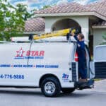 plumber unloading ladder from work van