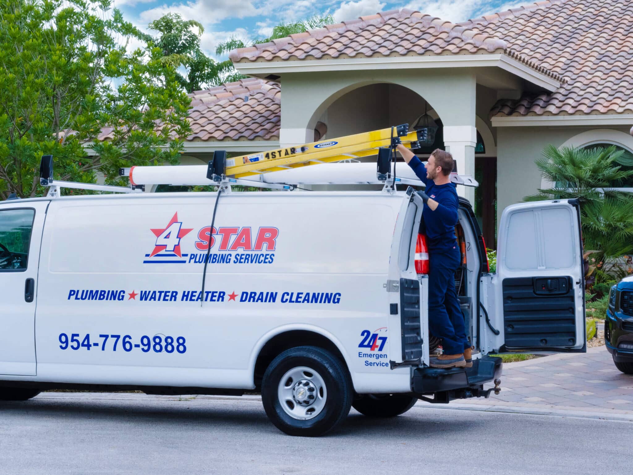 plumber unloading ladder from work van