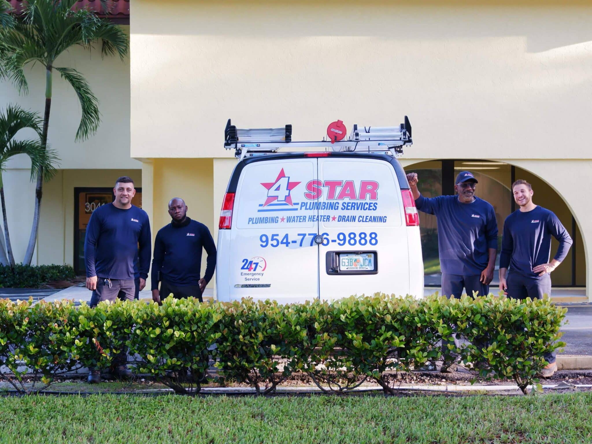 plumbers standing by 4 star service van