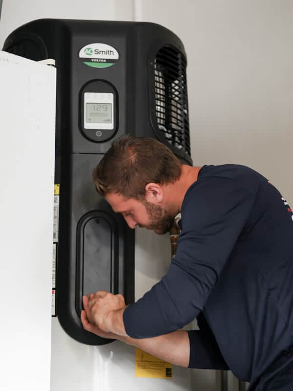 plumber fixing hyrbid water heater