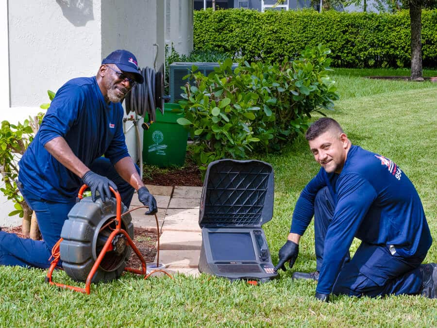 plumbers doing a sewer drain video inspection outside